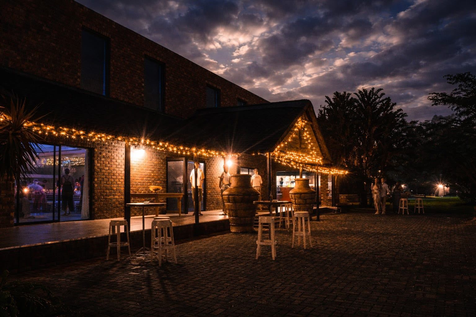 The Main Hall stoep strung with fairy lights as guests gather at night